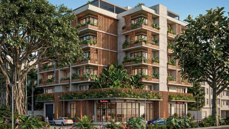 Maquete eletrônica fotorrealista de prédio residencial moderno com fachada de concreto e madeira, ilustrando a qualidade gráfica que define o preço do serviço.